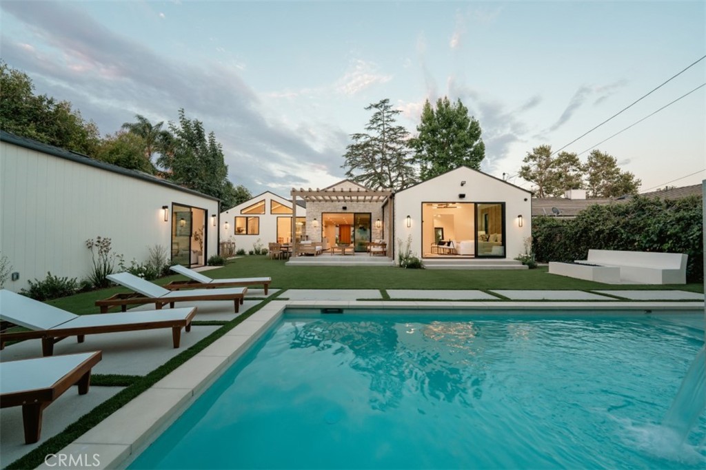 Nestled in a serene location of Toluca City, this stunning single-story home features 4 bedrooms 4 bath plus a 1 bedroom ADU with full kitchenet. The property boasts a natural and organic aesthetic that seamlessly blends with its lush surroundings. The home is framed by mature trees that provide privacy and tranquility, while its stone and wood elements exude warmth and elegance. As you step inside, you’ll be greeted by open floor with high ceilings, creating a grand & spacious ambiance. The interior design is characterized by natural tones and organic lines that add to the home's overall calming and soothing atmosphere. The open-concept living and dining area features large windows that allow natural light to fill the space, highlighting the beauty of the natural surroundings. The gourmet kitchen is equipped with state-of-the-art appliances and plenty of counter space, making it perfect for entertaining guests or preparing meals for your family. The bedrooms are generously sized, providing a comfortable and peaceful retreat for you and your loved ones. The bathrooms are designed with luxurious finishes, creating a spa-like experience. Equipped w/ smart home and a home office make it an environmentally friendly home. Outside, the swimming pool & covered patio is perfect for enjoying the beautiful California weather. The patio features a built-in BBQ and a fire pit, making it ideal for hosting outdoor gatherings with family and friends. The backyard is beautifully landscaped providing a serene and tranquil environment with a small  golf court for fun times! Overall, the stunning property offers the perfect combination of luxury, comfort, and natural beauty, making it an ideal place to call home. Located minutes away from Toluca lake village restaurants and shops.
