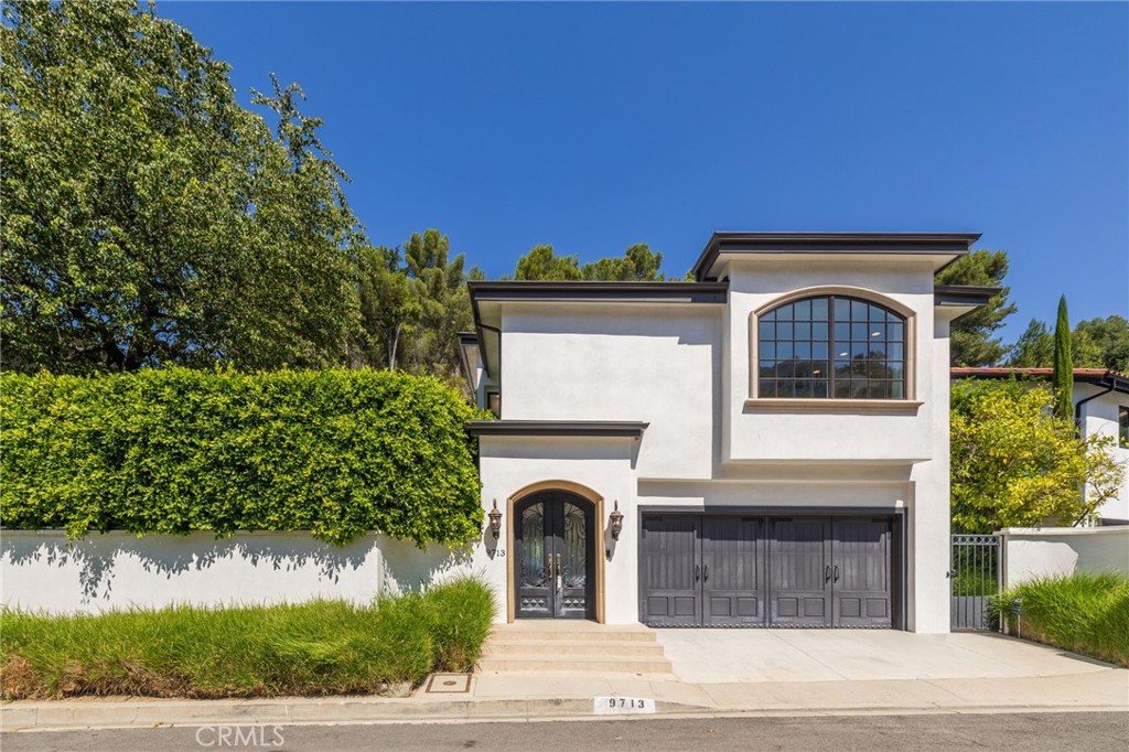 Sitting at the end of a private cul-de-sac, this gorgeous Mediterranean inspired home has the ideal floor plan and exceptional renovations inside and out.  The hardwood flooring, crown molding, and baseboards offer understated luxury. The living room, with a gas fireplace and expansive double sets of French doors showcases the private courtyard.  The adjoining dining room’s French doors seamlessly integrate indoor and outdoor living and an entertainment lifestyle. The gourmet kitchen is a culinary haven, boasting custom cabinetry, a center island with soft-closing drawers, and professional-grade VIKING appliances.  A versatile bedroom en suite, laundry area, guest half bath, and an expansive office or media room complete the first floor. Upstairs the primary suite is a sanctuary with three walk-in closets and built-in wardrobes.  The bath features recessed lighting, his and hers vanity, soaking tub, dry sauna, marble flooring, and a large stall shower.  Two additional bedrooms, built-in cabinets and a full bathroom complete the upstairs.  Relax and unwind by the sparkling pool and fire pit area with seating space. Serenely set with picturesque surroundings, this oasis offers a truly exceptional living experience in an exclusive Beverly Hills location.