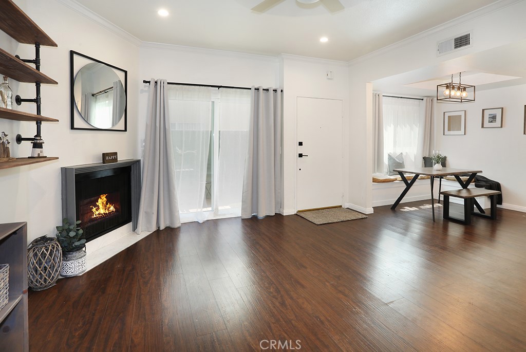 Your modern, gorgeously remodeled townhome in the heart of Toluca Lake awaits! Primely situated, this 2 bed 2 bath property exudes both charm and sophistication throughout along with the most spectacular rooftop patio with hillside views and nightly firework shows from Universal Studios! Step inside the open concept kitchen and family room area, filled with plentiful natural light with crown moulding, recessed lighting and beautifully appointed in rich wood style flooring with cozy custom mantled fireplace. Enjoy the private enclosed downstairs patio just off the family room  and daily dining with custom banquette seating with extra storage beneath. The pristinely updated kitchen is an absolute delight, adorned in crisp white shaker cabinetry with rechargeable under lighting, quartz counters, marble tile backsplash and stainless steel appliances including a deep single basin sink. An additional under stairs pantry adds plenty of room for extra storage and convenience. The impeccable downstairs bath features a single custom vanity with an impressive glass enclosed walk in rain shower adorned in dramatic tile. Conveniently completing the downstairs is an in closet stackable washer and dryer. As you head upstairs, you’ll notice the sleek iron stair railing as you enter the spacious bedrooms, equipped with ceiling fans and walk in closets with custom metal organizers. The upstairs bath delights with dual vanities with Carrera marble counters, custom floating shelves and a shower with tub outfitted in chic subway tile. Just above, you’ll discover an abundant entertaining space on the rooftop deck, which is one of the largest in the building! With year round functionality, you’ll enjoy sun soaked afternoons watching the outdoor Roku TV or cooler nights gathered around the fire pit. Furry family members will love the added turf area too! Enjoy tandem garage parking conveniently located below the unit along with gated access. Reasonable HOA includes a pool, recreation room, water and trash. Located minutes from the 101, 134 and 170, freeways, major studios, walking distance to many local coveted restaurants and shops and some of the best hiking trails LA has to offer! Enjoy a taste of the good life- both inside and outside your door, what are you waiting for?!