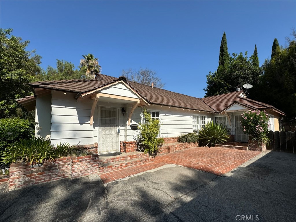 Presenting a unique investment opportunity at 10559 Camarillo St, Toluca Lake, featuring a versatile property with dual-unit potential. This 1,859 sq ft residence, set on a 6,984 sq ft lot, offers an ideal configuration for maximizing rental income or multi-generational living. Property is Currently configured as two, 2 bedroom, 1 bath units, with kitchens and individual laundry rooms. 
The backyard offers a tranquil retreat with a delightful pergola-covered patio, ideal for outdoor dining and relaxation. Additionally, a detached 2-car garage provides ample storage and parking space. This home is a rare find in a prime location, offering a blend of comfort and convenience at an attractive price.
