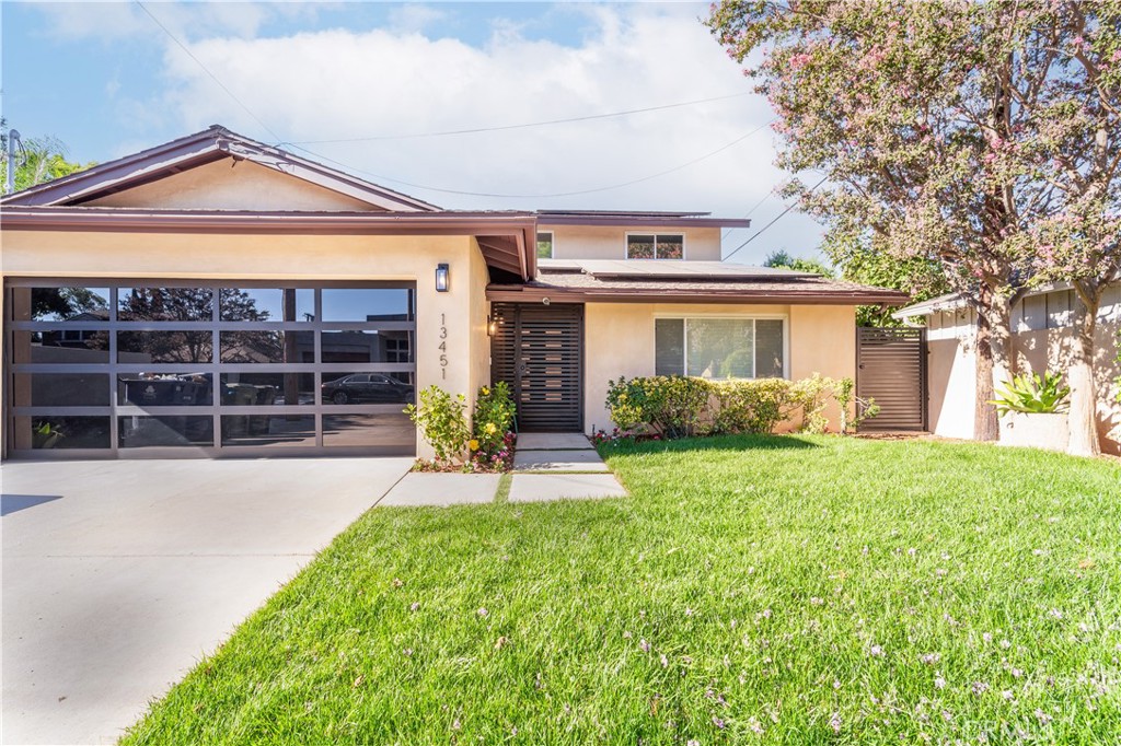 Step into this stunning, fully remodeled two-story residence, a true modern marvel that must be seen to be fully appreciated. This home has been meticulously renovated with impeccable taste and attention to detail, seamlessly blending functionality, cutting-edge technology, and contemporary style into a perfect forever home. Featuring a spacious open floor plan, this residence includes 4 bedrooms and 3 bathrooms. Upon entering, you'll immediately notice the sense of openness, highlighted by new engineered hardwood flooring, an electric fireplace, smooth ceilings with recessed lighting, and elegant custom chandeliers. The captivating open kitchen boasts exquisite cabinetry and quartz countertops, complemented by Thermador stainless steel appliances, including a built-in refrigerator, cooktop, double oven, and microwave. Additional highlights include lavish custom bathrooms, central air and heat, a solar system, and a tankless water heater. The resort-like backyard is a serene retreat, surrounded by lush landscaping and featuring a beautiful pool. Situated in a picturesque neighborhood with beautiful streets, this home offers convenient proximity to Fashion Square, the 101 and 405 freeways, exceptional shopping, fine dining, and entertainment. Access to West LA is also effortless.