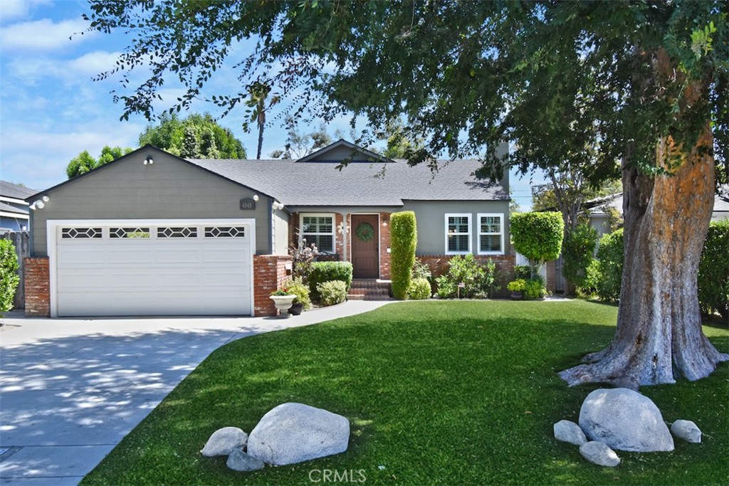 Presenting a charming traditional-style home located in the sought-after Toluca Woods neighborhood, this single-story property blends elegance and comfort. Spanning an efficient open floor plan, the residence includes three generously sized bedrooms and two well-appointed baths. The interiors are bathed in an abundance of natural light, enhanced by elegant plantation shutters throughout, creating a bright and airy atmosphere. Central to the home are two cozy fireplaces—one nestled in the welcoming living room and another in the spacious den, the perfect spot for family and friends to gather for game nights or to binge-watch their favorite shows. This inviting den flows seamlessly into a kitchen equipped with sleek granite countertops and stainless steel appliances. The indoor living area transitions smoothly to a large backyard, featuring a refreshing swimming pool ideal for hosting and relaxation. The property is maintained with meticulous attention to detail and boasts numerous upgrades, ensuring a turnkey experience for prospective homeowners. Residents will appreciate the short walk to Toluca Village, where community ties are strong and local merchants know their customers by name. The home also offers unparalleled access to top-tier schools, major television and film studios, and iconic cultural venues such as the Hollywood Bowl and Griffith Park. This residence offers more than just a place to live—it's your choice for a lifestyle filled with comfort, culture, and community.