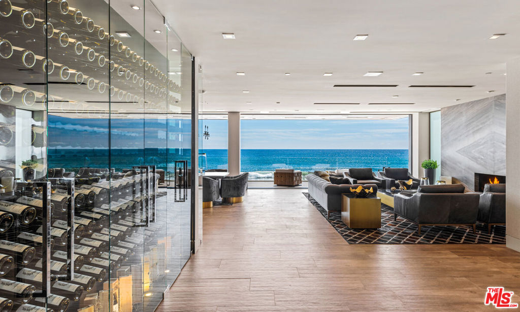 One of the finest and most distinguished ocean front homes in California. A masterpiece, located on Carbon Beach, also known as Billionaire's Beach, is the pinnacle of luxury, design and elegant comfort. Explosive panoramic ocean and whitewater views, from all three levels, from Palos Verdes to the Malibu Pier and beyond. Rare 3rd level with indoor-outdoor living. An entertainer's dream home fusing luxury, design and technology. Step into the gated, private courtyard entry with alluring waterfall wall feature, concrete fire table and dramatic glass front doorway revealing the incredible ocean views awaiting. Upon entry, one touch of a button, automated shades rise in harmony with Fleetwood doors gliding open the entire width of the main level, allowing the sounds of the waves to fill the space and indulge the senses. Captivating main level is elegantly furnished with comfort and entertainment in mind. A floating glass and wood staircase, imported Italian slab fireplace masterfully set like a piece of art, and beautiful glass climate-controlled wine wall attract attention. High end, custom designed chef's kitchen with center island and breakfast counter, home theater, ensuite bedroom, a powder room, 2-car garage with direct access, and a pneumatic elevator that services all 3-levels completes the main level, outdoor roof-top access and direct beach access with 2-outdoor showers. The 2nd level encapsulates an ultra-chic, ocean viewing owners retreat with fireplace, sitting area - currently a yoga room, automated doors to deck with fire-pit, luxurious bath with steam shower, spa tub and custom walk-in closet. Additionally, there are two-ensuite guest rooms and a floor-to-ceiling glass fitness room. The 3rd level, designed for impressive world class entertaining and ultimate relaxation with indoor-outdoor ocean view living. Sexy ensuite with ocean views, a living room with fireplace and sliding glass door to a spectacular deck with center island that seats 12 around the fire table, a BBQ island with kitchen, lounge area with fire pit, hot tub and direct access to the courtyard entry. Fully automated Creston system controls, doors, lights, shades, sounds system, temperature, etc., fusing modern comforts with the finest craftsmanship.