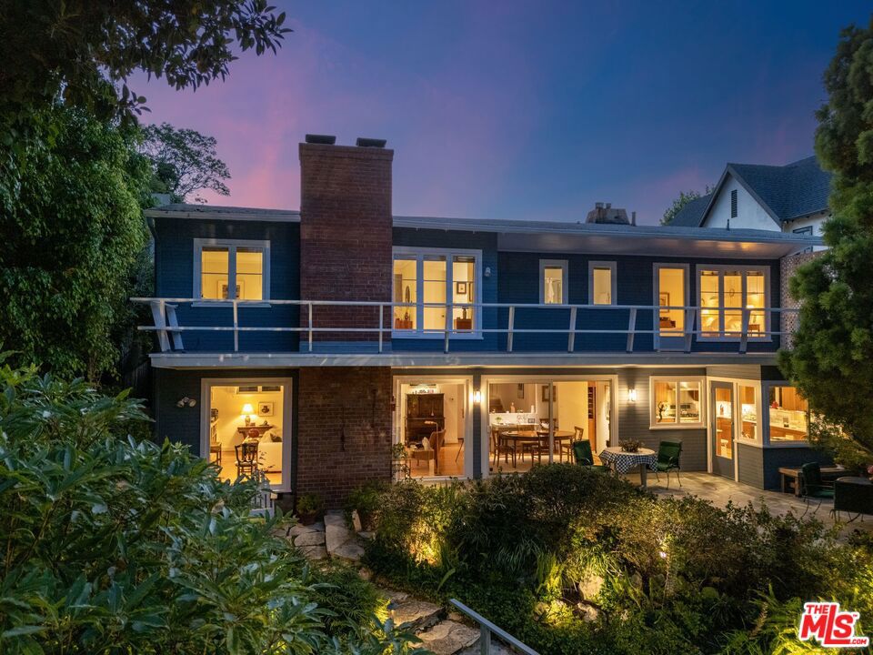 Discover a serene oasis crafted by architect Alfred Truesdell Gilman in 1950. This gem of a house is built to integrate seamlessly with nature, featuring large windows that provide stunning views of the surrounding garden from nearly every room. The multi-leveled yard, designed by Joe Copp, acclaimed landscape architect of the Hotel Bel-Air and former owner, remains a masterpiece of botanical beauty. A gently flowing natural spring-fed stream, with lily pond, winds under a bridge through the property, creating a habitat for local wildlife, including snowy egrets & mallard ducks. Flowering bushes and trees bloom abundantly, adding vibrant color and tranquility all year long to the park-like setting. A lap pool & spa complements the grounds' aesthetic, offering a private sanctuary for relaxation next to the grassy lawn and rose garden. The home's expansive lot is unusually generous for its size, providing an ample & versatile space for gatherings. It has served as a destination for weddings, art shows, garden tours, and other memorable occasions. Located in the desirable Brookside neighborhood, the home is just minutes from Larchmont Village and easily accessible to Downtown, Hollywood, Beverly Hills, and Century City.  Embrace the rare opportunity to own an unexpected & unique urban Eden, and enjoy a life of beauty and inspiration in this captivating retreat.