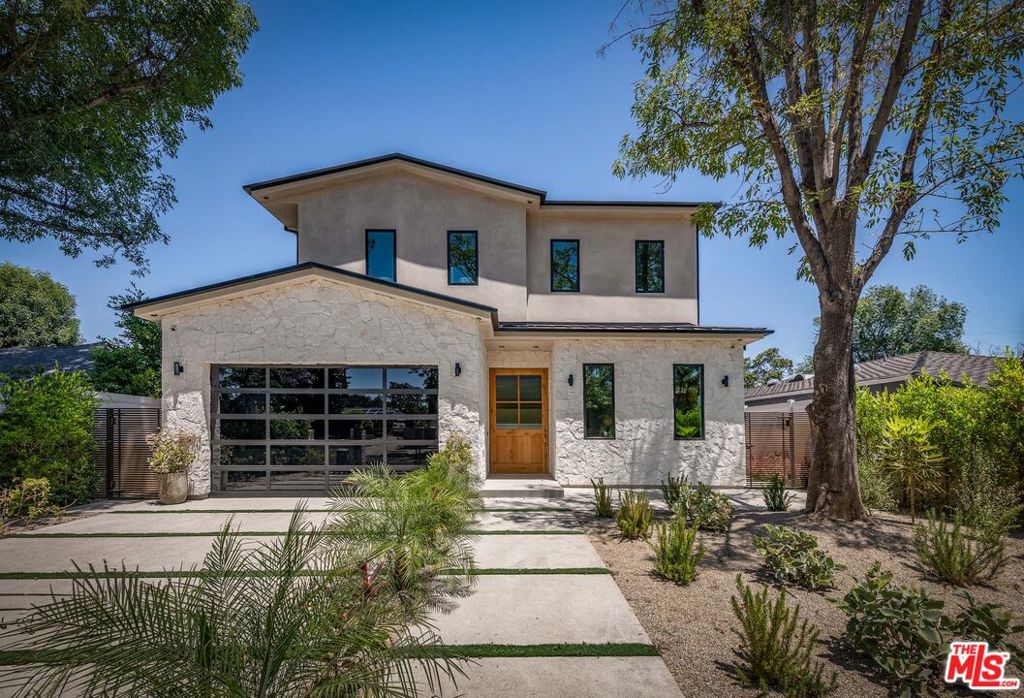 Introducing a completely reimagined basement home located within one of the most desirable pockets of Sherman Oaks. This stunning 6BD/8BA residence is filled with designer finishes and embodies perfection in every detail. As you enter, you are greeted by a grand open floor plan bathed in natural light. The formal dining room features custom-built-in cabinetry and seamlessly extends to a covered outdoor patio, ideal for al fresco dining. The chef's kitchen is a culinary haven with Thermador appliances, sparkling countertops and custom cabinetry. Adjacent to the kitchen, the living room boasts another fireplace, built-ins, and floor-to-ceiling glass stacking doors that effortlessly merge indoor and outdoor living. The main level of the home also includes a powder bath and an ensuite guest bedroom. Upstairs, the primary suite awaits with vaulted ceilings, a fireplace, a huge custom walk-in closet, and a private balcony overlooking the backyard. The exquisite spa-like bath offers dual vanities and a wet room with a spacious shower and soaking tub. Three additional ensuite bedrooms and a laundry room complete the upper level. The basement level of the home offers an additional living room with stacking glass doors that lead you out to an outdoor covered patio as well as a powder bath, movie theater, gym and an ensuite bedroom. The resort-like backyard is equipped with a pool with waterfall, spa, fire pit with seating area, built in barbecue with an island and plenty of space to entertain. Conveniently nestled in the heart of Sherman Oaks, just minutes away from the vibrant shopping and dining options along Ventura Boulevard, this home offers the ultimate blend of luxury and convenience. Welcome to the perfect home to compliment a lifestyle of refined living.