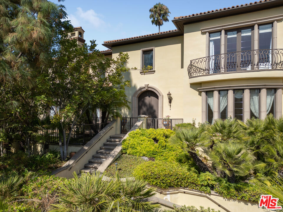 Nestled behind The Beverly Hills Hotel with captivating city views, this stunning gated Tuscan Mediterranean villa offers a rare blend of elegance and privacy. Built in 1995 and beautifully enhanced, this 9,000 sq ft residence features 4 bedrooms and 7 baths, with breathtaking Venetian plaster finishes added in 2010. From the grand marble entryway to the skylights, exquisite hardwood floors, coffered ceilings, and tall French doors, every detail exudes sophistication. The formal dining room is adorned with refined moldings, crystal sconces, and a custom media center. The luxurious master suite includes a spacious sitting area and separate his-and-hers baths, while a handsome study, a three-level elevator, and Sherle Wagner fixtures add to the allure. The exterior is equally enchanting, with a lush pool area, spa, outdoor chef's kitchen, and BBQ space complemented by tranquil fountains. A custom 5-car garage and a 1,285-bottle wine cellar elevate this residence to a level of unmatched exclusivity.