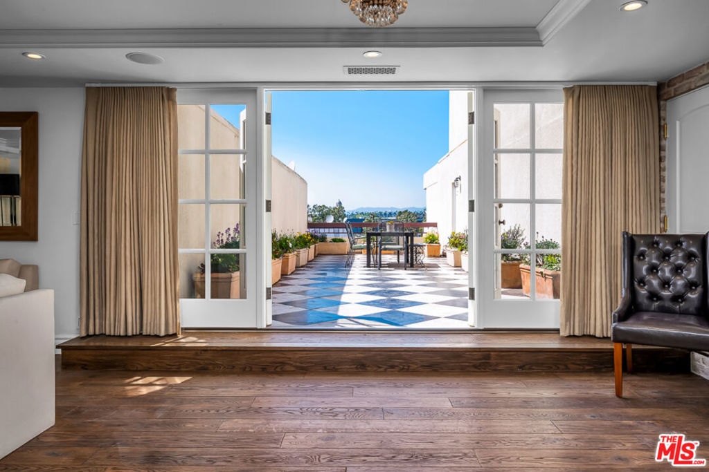 Presenting this palatial penthouse with breathtaking views of the Westside to downtown Los Angeles, towering floor to ceiling windows with natural light aplenty, and a centerpiece of a spiral staircase that leads to the second floor-equipped with a private marbled floor balcony. Nestled in the coveted neighborhood, Beverly Hills Flats, access to all the finest dining, markets, and shops are all conveniently nearby. Spanning 3,233 square feet with 2 bedrooms and 3 bathrooms, this penthouse offers a vast living space, kitchen, and formal dining space, with another sitting area on the 2nd floor that can be used as an office, media room, or more. The spacious primary suite features a separate office space and a stunning en suite bath fitted with a clawfoot bathtub, shower, and a vanity area reminiscent of old Hollywood Glamour. Additional features include a charming marigold built-in kitchen nook, a second floor wet bar, and a dressing area that displays all your favorite pieces. Building amenities include a rooftop pool, 24 hour door service, gym and community room with bar and kitchen. Meticulously designed by a celebrity and featured in InStyle magazine, this penthouse is a must-see.